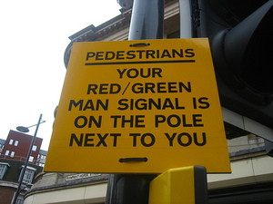 Sign on traffic signals: Your red/green man signal is on the pole next to you