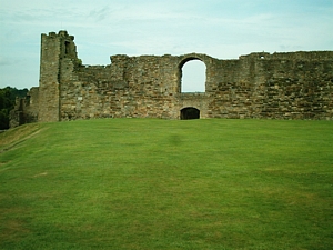 Richmond Castle: Photograph showing the slightly obscured postern gate in the west curtain with the open arch above and a flanking tower