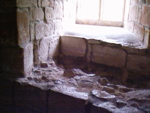 Skipton Castle: Photograph of the interior of a window within one of the inner curtain towers. The change to thinner masonry marking Lady Anne Clifford's repairs is clear